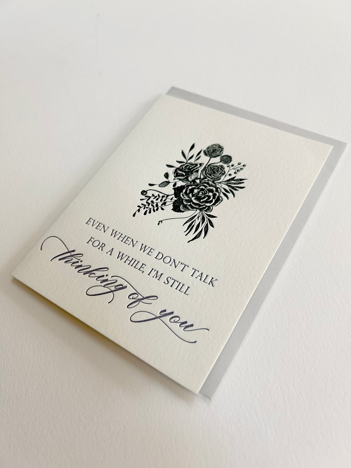 Letterpress greeting card with black inked florals that reads "Even when we don't talk for a while, I'm still thinking of you" in purple ink by Rust Belt Love.