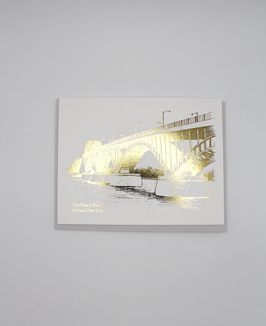 Gold foil peace bridge illustration card that reads "The Peace Bridge Buffalo, New York" by Rust Belt Love