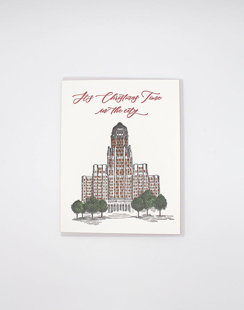 Letterpress greeting card with Buffalo's city hall illustrated on it that reads "It's Christmas Time in the city" by Rust Belt Love.