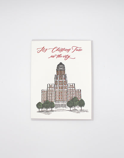 Letterpress greeting card with Buffalo's city hall illustrated on it that reads "It's Christmas Time in the city" by Rust Belt Love.