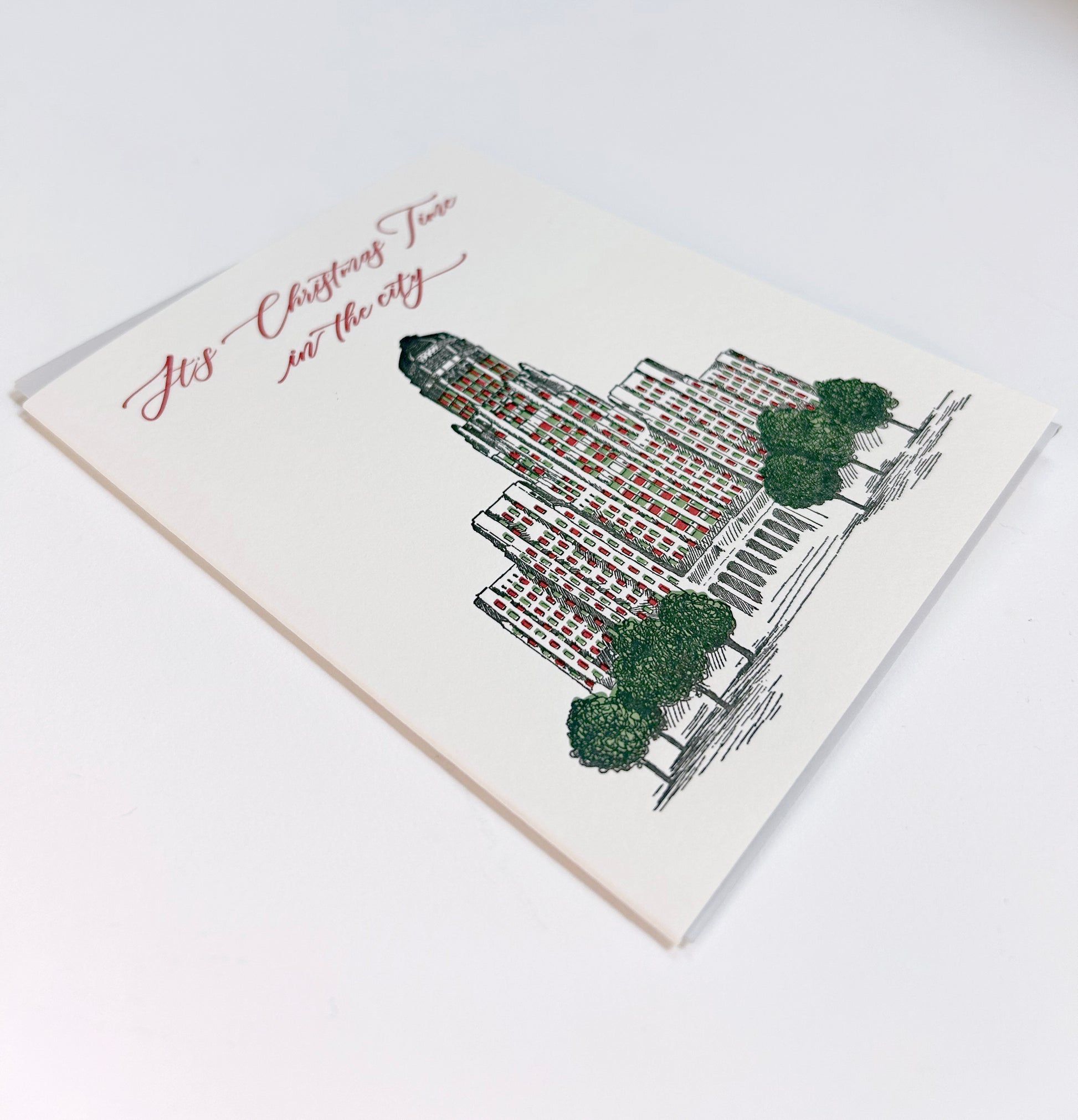 Letterpress greeting card with Buffalo's city hall illustrated on it that reads "It's Christmas Time in the city" by Rust Belt Love.