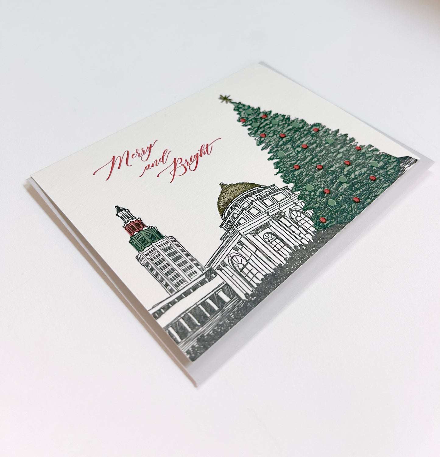 Letterpress holiday card of Downtown Buffalo that reads "Merry and Bright" from Rust Belt Love