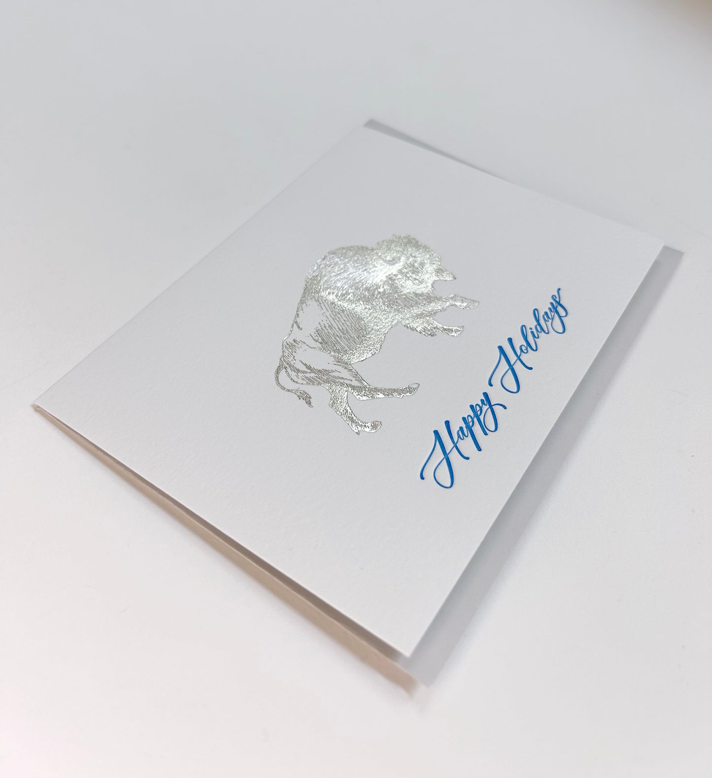 Silver buffalo greeting card that reads "Happy Holidays" in blue ink, by Rust Belt Love