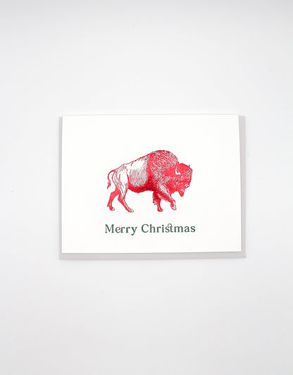 Red foil buffalo greeting card by Rust Belt Love that reads "Merry Christmas"