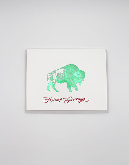 Letterpress and green foil buffalo greeting card that reads "Season's greetings" in red ink, by Rust Belt Love