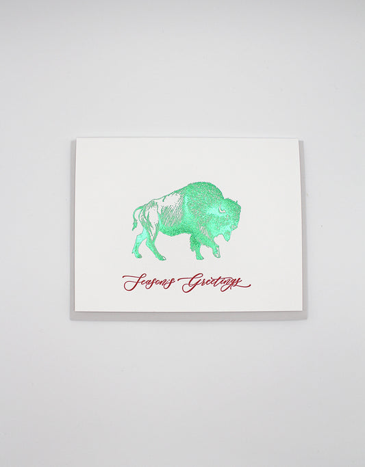 Letterpress and green foil buffalo greeting card that reads "Season's greetings" in red ink, by Rust Belt Love