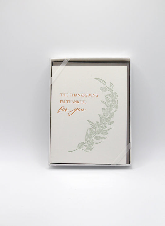 Box of letterpress thanksgiving cards with greenery that says "This Thanksgiving I'm Thankful For You" by Rust Belt Love