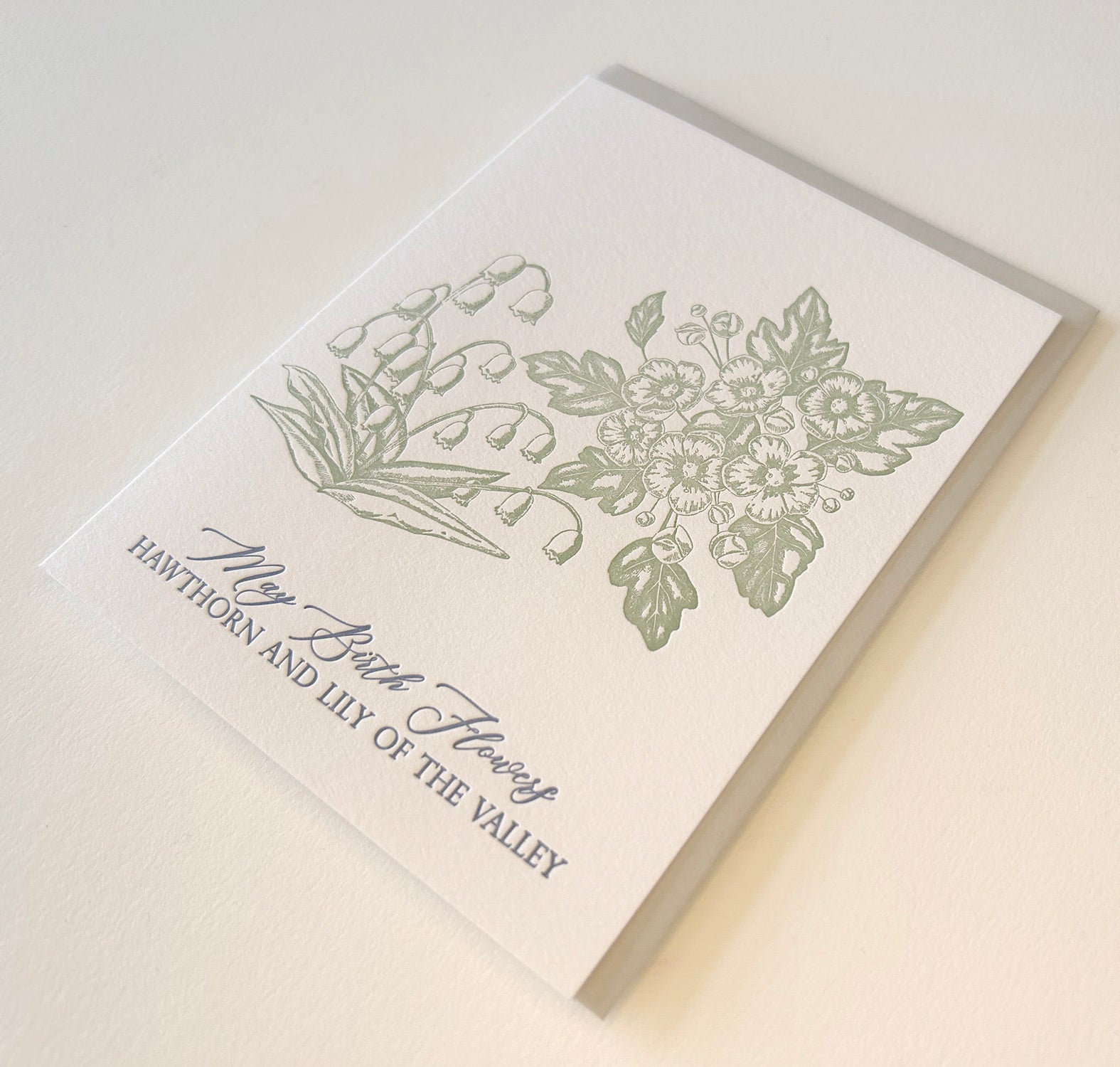 Letterpress card with florals that reads "May birth flowers hawthorn and lily of the valley" by Rust Belt Love