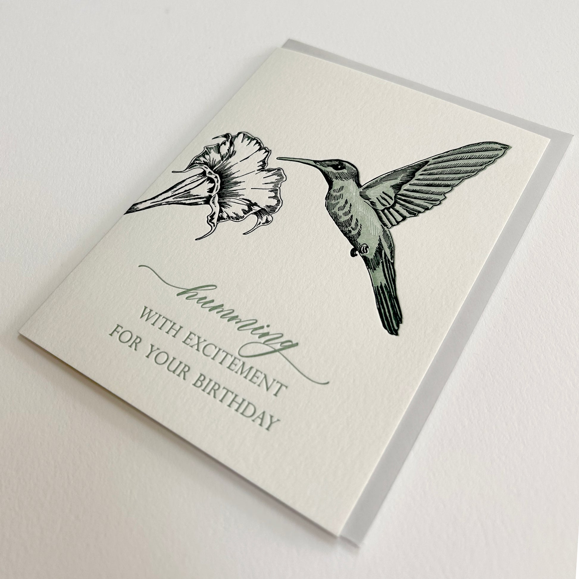 Letterpress birthday card with a flower and humming bird that reads "humming by with excitement for you birthday", by Rust Belt Love