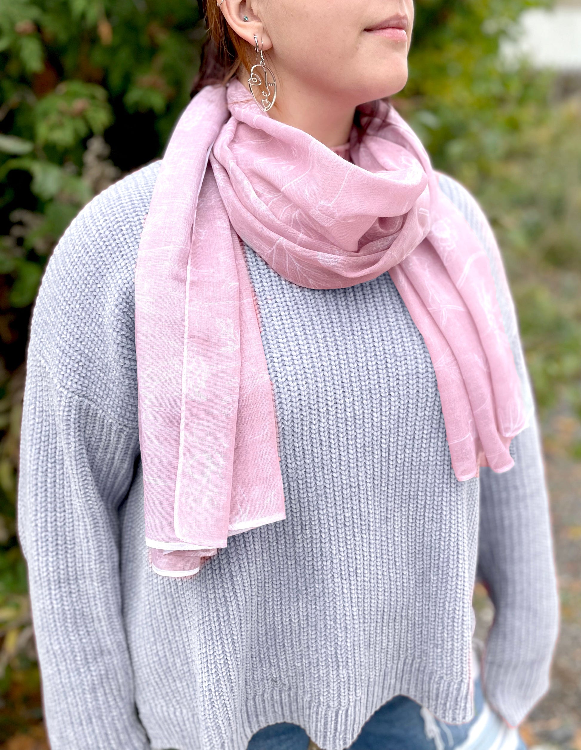 Woman modeling blush floral scarf by Rust Belt Love