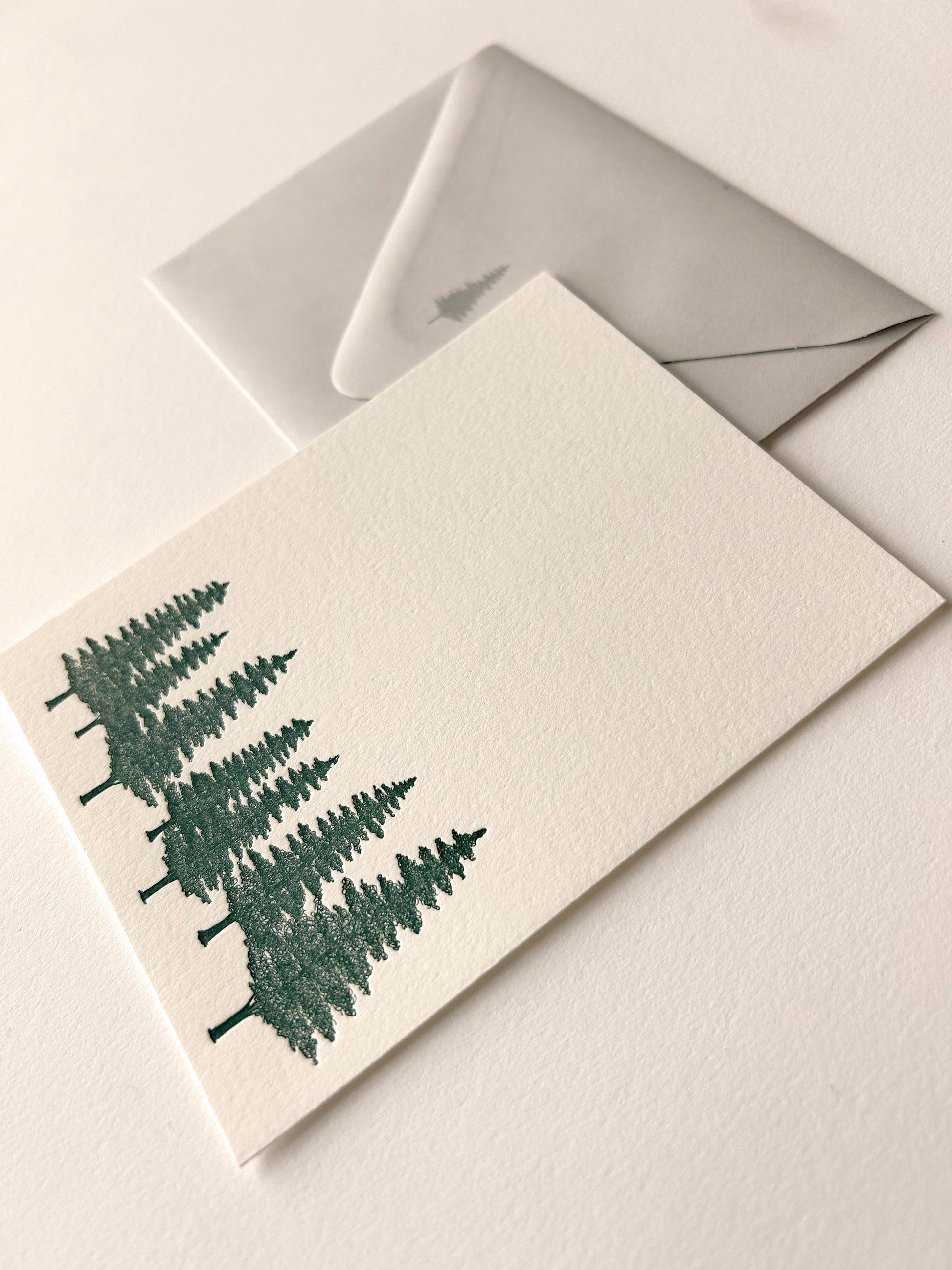 Letterpress note card with green evergreens on it by Rust Belt Love