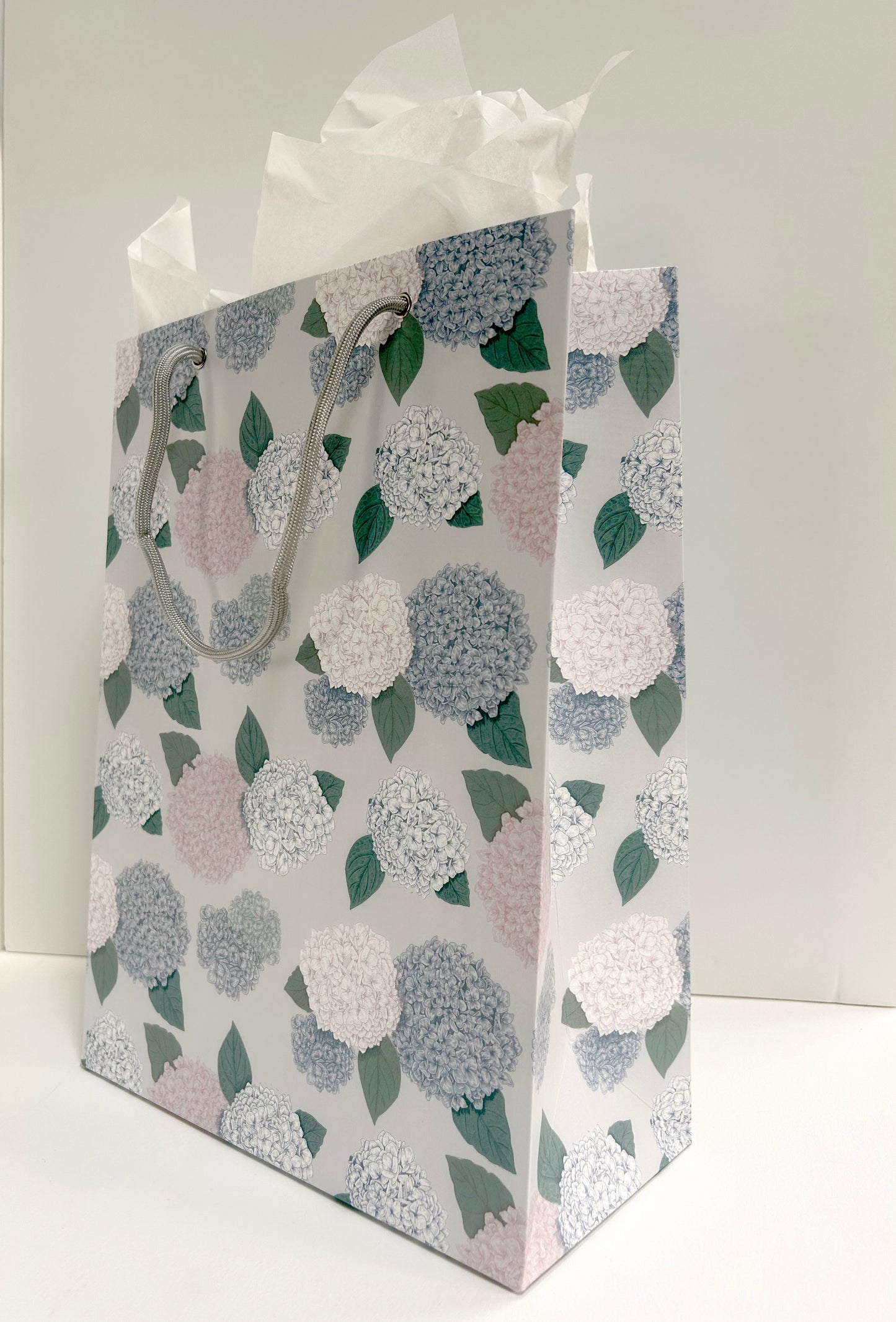 Angled picture of standing gift bag printed with hydrangea pattern by Rust Belt Love