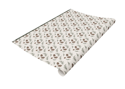 Roll of Rust Belt Love's pinecone and greenery patterned wrapping paper