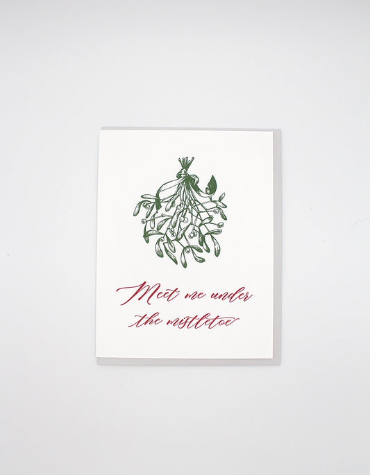 Letterpress holiday card with mistletoe that says "Meet me under the mistletoe" by Rust Belt Love