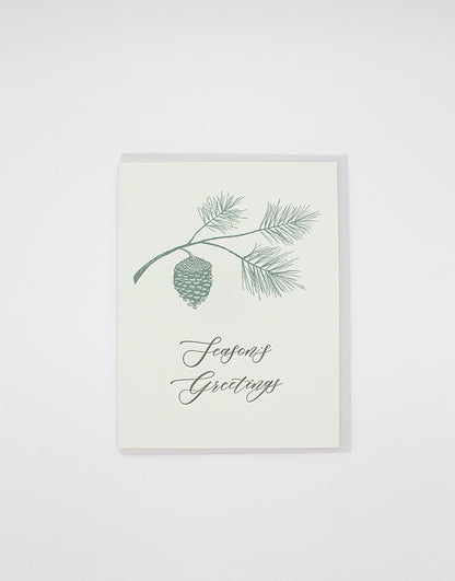 Letterpress holiday card with pinecone that says "Season's greetings" by Rust Belt Love