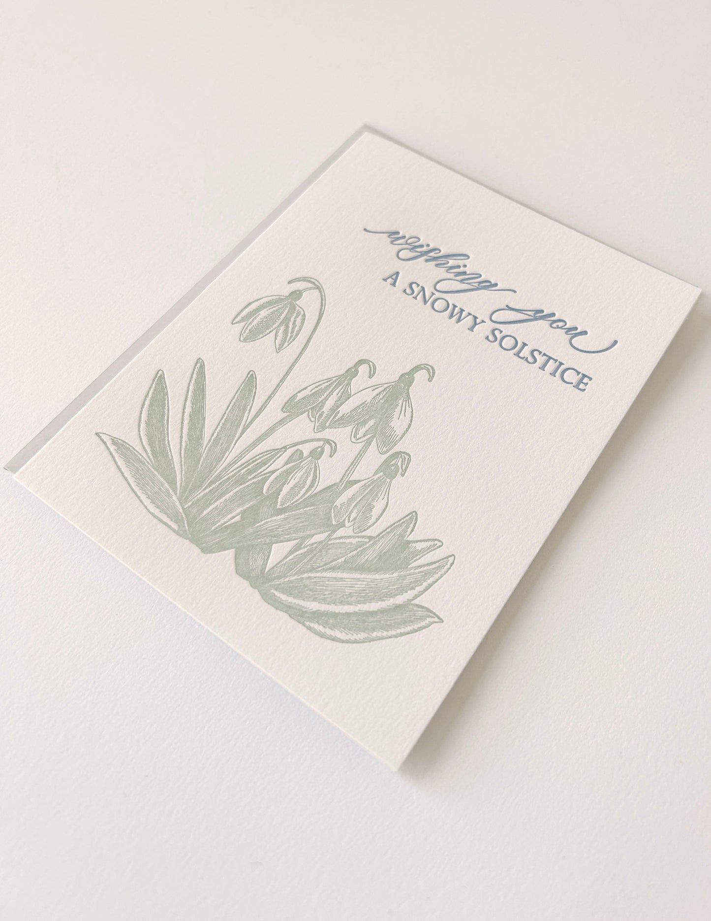 Letterpress holiday card with snowdrop flowers that says "Wishing You A Snowy Solstice" by Rust Belt Love