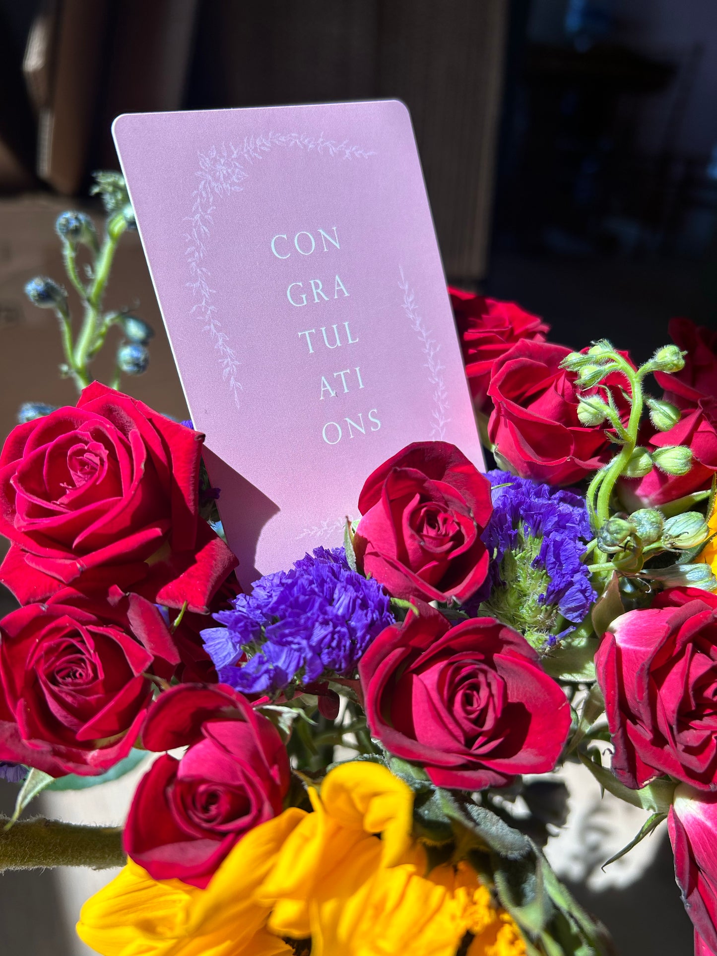 Pink floral minicards that reads "Congratulations" by Rust Belt Love placed in a bouquet of flowers