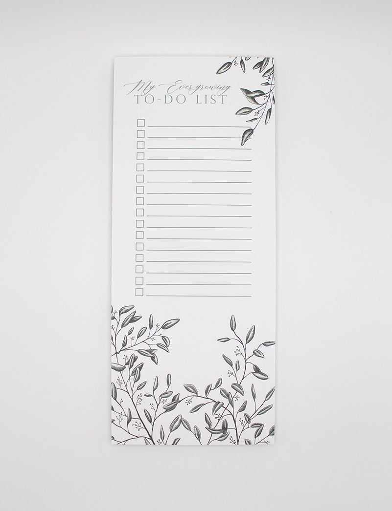 Style shot of a 3.5 by 8.5 notepad with lined sheets with florals that says "My ever-growing to-do list" by Rust Belt Love