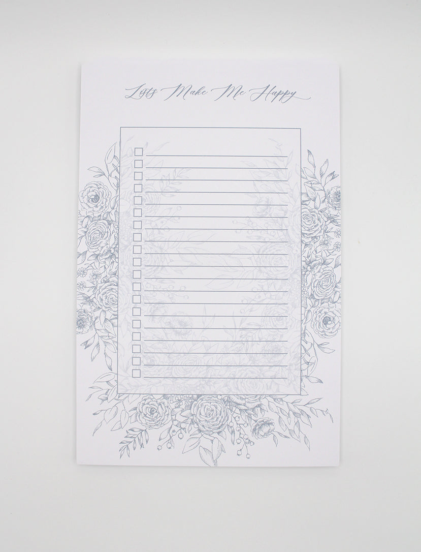 5.5 by 8.5 notepad with lined sheets with blue florals that says "Lists make me happy" by Rust Belt Love