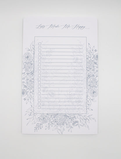 5.5 by 8.5 notepad with lined sheets with blue florals that says "Lists make me happy" by Rust Belt Love