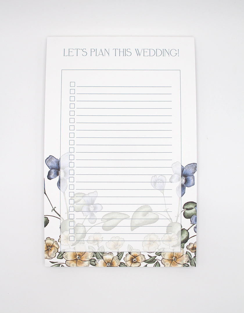 Rust Belt Love's floral lined paper notepad that reads "Let's plan this wedding!"