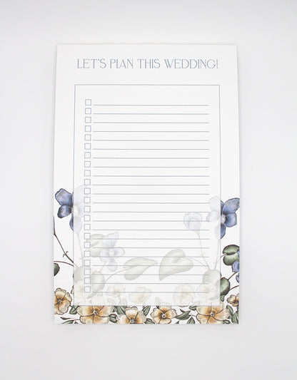 Rust Belt Love's floral lined paper notepad that reads "Let's plan this wedding!"