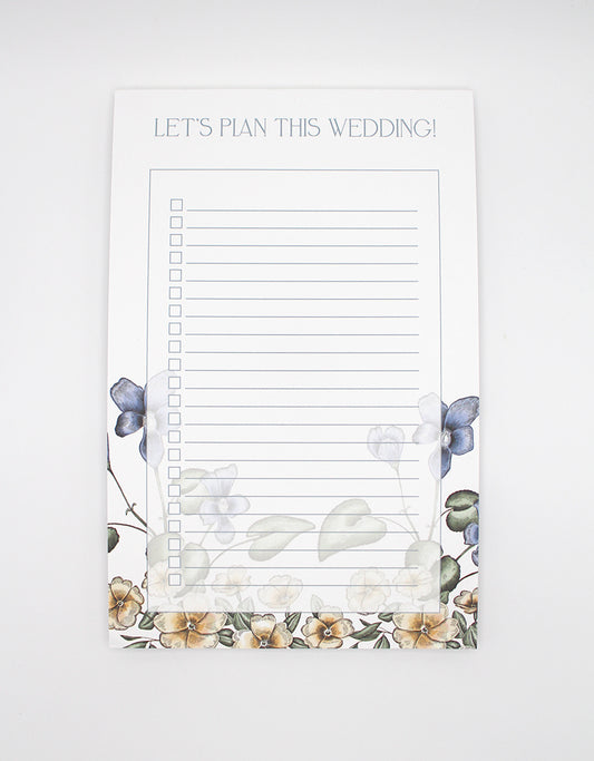 Rust Belt Love's floral lined paper notepad that reads "Let's plan this wedding!"