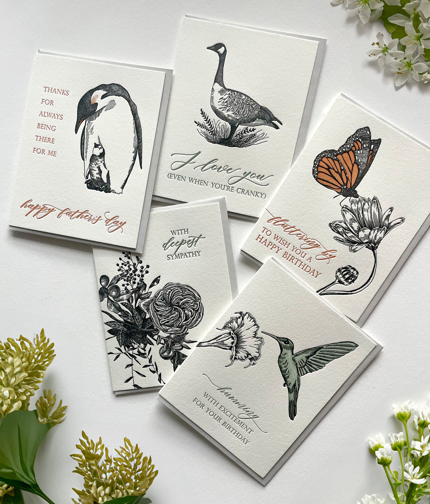 A variety of black ink letterpress greeting cards.