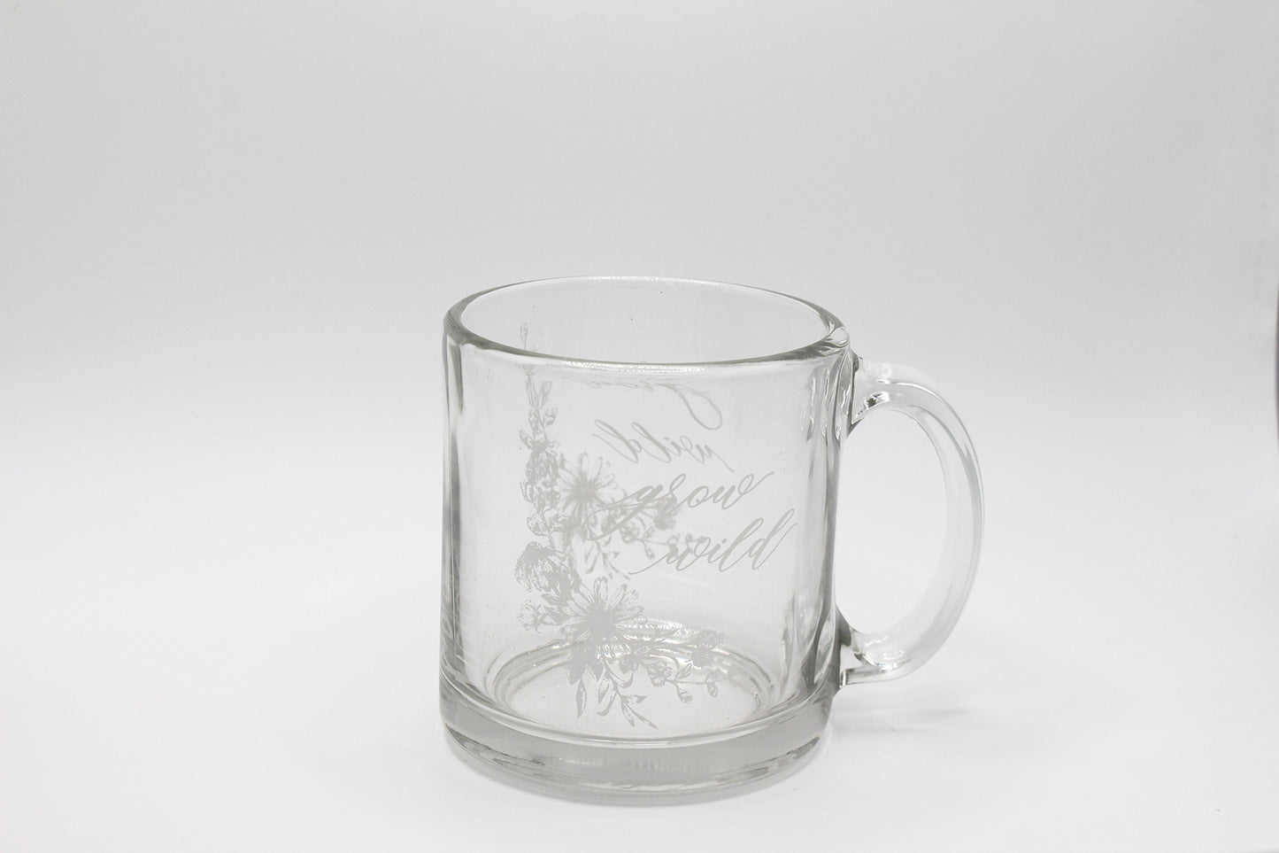 White ink on clear glass mug with flowers and that says "grow wild" by Rust Belt Love