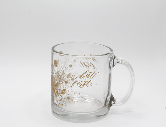 Gold ink on clear glass mug with florals and that says "but first..." by Rust Belt Love