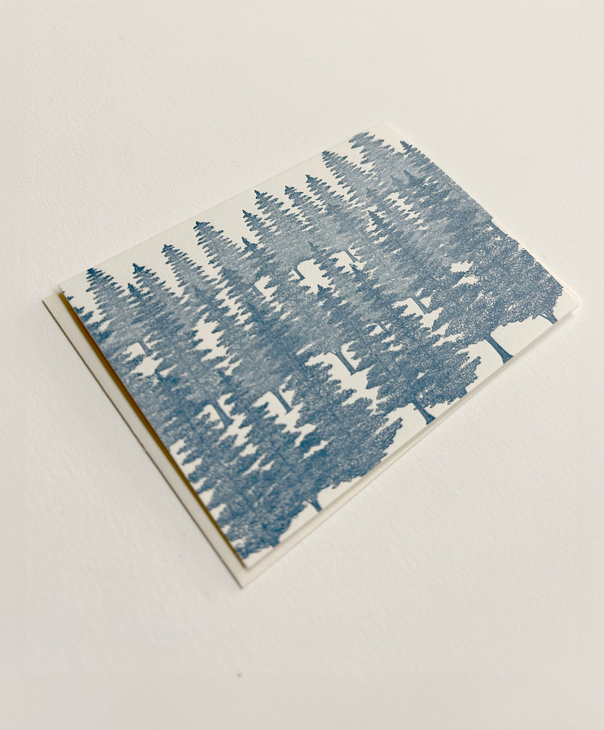 Small letterpress note card with blue evergreens on it by Rust Belt Love