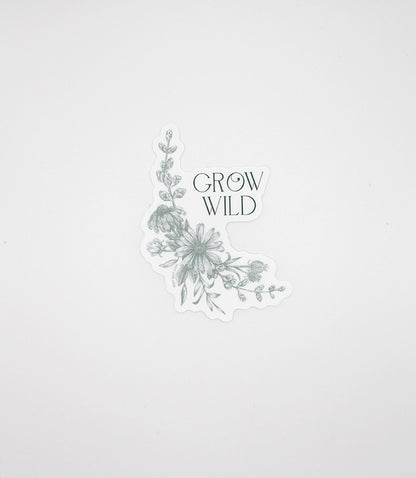 Green floral sticker that reads "Grow wild", by Rust Belt Love