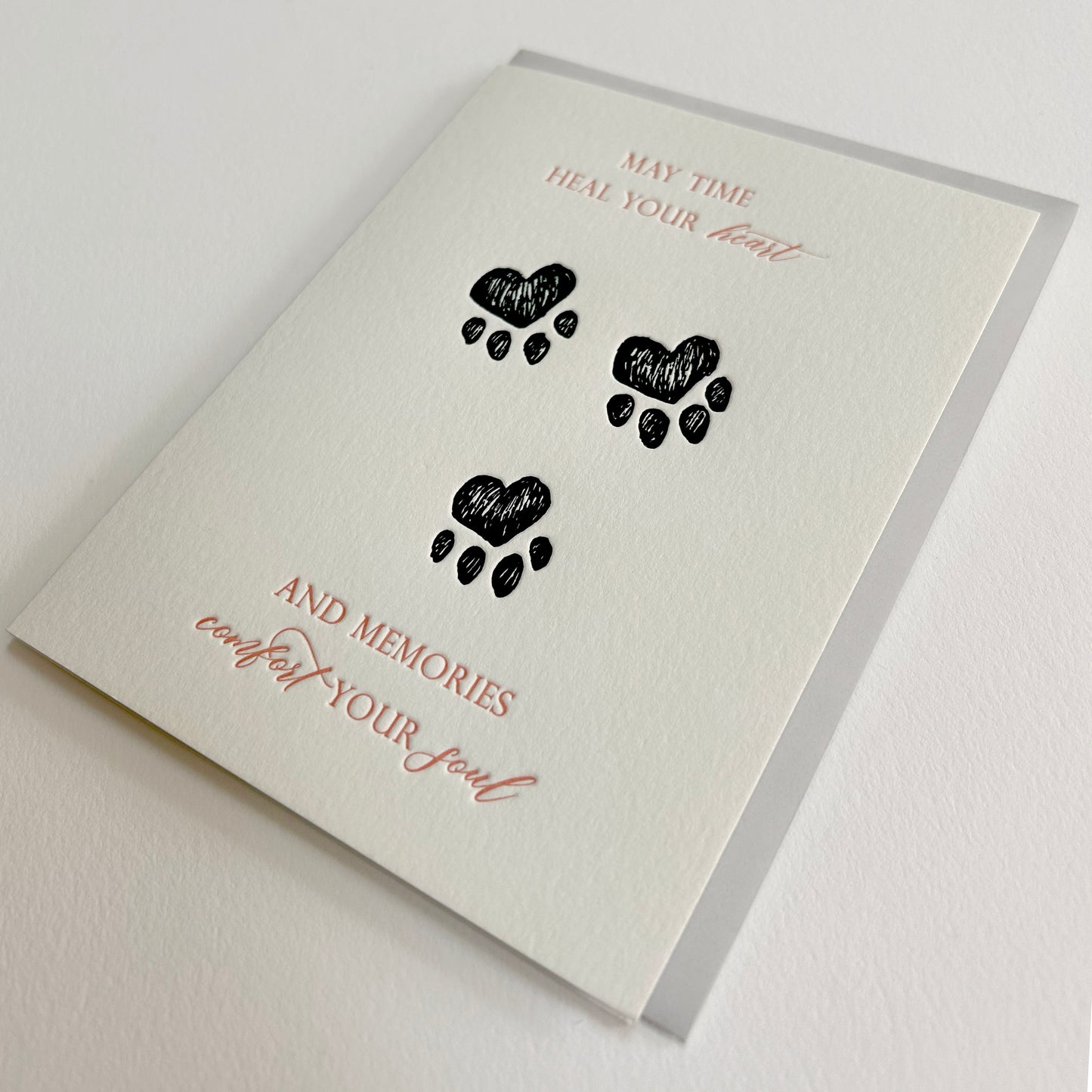 Letterpress sympathy cards with paw prints from Rust Belt Love, that reads "May time heal your heart and memories comfort your soul"