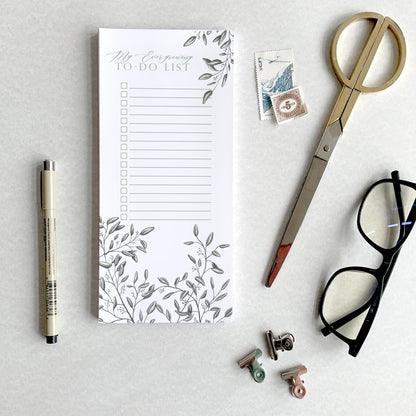 Style shot of a 3.5 by 8.5 notepad with lined sheets with florals that says "My ever-growing to-do list" by Rust Belt Love