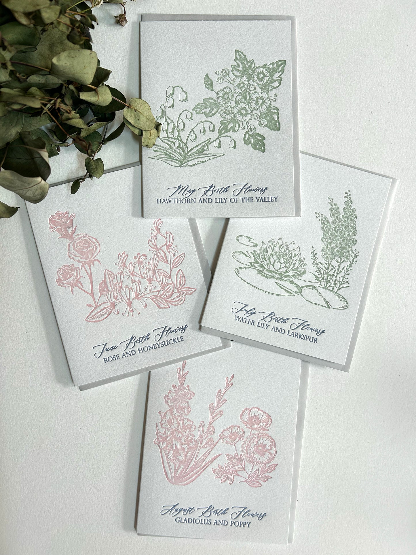 Style shot of Rust Belt Love's summer birth flower letterpress cards.