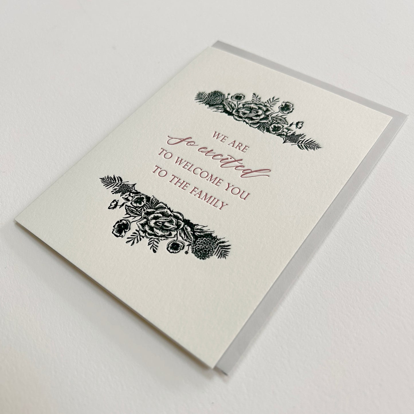 Letterpress greeting card with black florals that reads "We are so excited to welcome you to the family" by Rust Belt Love